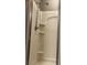 Bathroom shower with modern showerhead, built-in shelving, and clean, bright white walls at 1087 Jackson St, The Villages, FL 32162