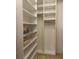 Spacious walk-in closet featuring built-in shelving and ample storage for organized living at 1087 Jackson St, The Villages, FL 32162