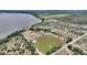 Expansive aerial view of waterfront home with a pier, lake access, and lush greenery at 1395 S Lake Reedy Blvd, Frostproof, FL 33843