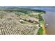 Sweeping aerial view displays lakefront house among sprawling orchards, close to recreational lake at 1395 S Lake Reedy Blvd, Frostproof, FL 33843