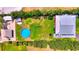 Aerial shot of home with a pool, patio area, lush grass, and mature trees at 1395 S Lake Reedy Blvd, Frostproof, FL 33843