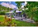 Beautiful backyard with a screened patio and a landscaped yard with mature trees at 1395 S Lake Reedy Blvd, Frostproof, FL 33843