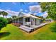 Charming backyard with a screened-in porch, swing, lush greenery, and outdoor storage at 1395 S Lake Reedy Blvd, Frostproof, FL 33843