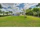 Expansive backyard with a pool, tiki hut and view of the water provides a private, outdoor oasis at 1395 S Lake Reedy Blvd, Frostproof, FL 33843