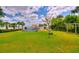 Expansive backyard featuring a pool, tiki hut, and lush landscaping, perfect for outdoor entertaining at 1395 S Lake Reedy Blvd, Frostproof, FL 33843
