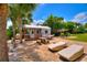 Charming backyard cottage with stone patio, lounge chairs, and hammock at 1395 S Lake Reedy Blvd, Frostproof, FL 33843