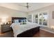 Primary bedroom featuring a ceiling fan, plantation shutters, and hard wood floors at 1395 S Lake Reedy Blvd, Frostproof, FL 33843