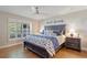 Comfortable bedroom with dark wood bedframe, hardwood floors, and natural light at 1395 S Lake Reedy Blvd, Frostproof, FL 33843