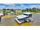 Aerial view of waterfront property featuring a boat dock, lifts, and views of the water at 1395 S Lake Reedy Blvd, Frostproof, FL 33843