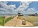 Wooden dock with a seating area and boat house offers waterfront access at 1395 S Lake Reedy Blvd, Frostproof, FL 33843