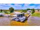 Dock with boat lift, covered area, and second story screened-in porch at 1395 S Lake Reedy Blvd, Frostproof, FL 33843