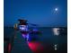 Nighttime shot of a dock with a boat lift, offering a peaceful waterfront retreat at 1395 S Lake Reedy Blvd, Frostproof, FL 33843