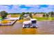 Elevated view of the boat dock with boat lifts, boat house, and seating area at 1395 S Lake Reedy Blvd, Frostproof, FL 33843