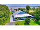 Waterfront home with metal roof, blue siding, and a nice yard with a pool and dock at 1395 S Lake Reedy Blvd, Frostproof, FL 33843