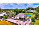 Backyard oasis with lush landscaping, a tiki hut, and an above-ground pool at 1395 S Lake Reedy Blvd, Frostproof, FL 33843