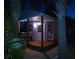 Inviting small house with a cozy deck illuminated at night at 1395 S Lake Reedy Blvd, Frostproof, FL 33843