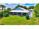 Spacious home boasting a large, well-maintained lawn, screened lanai, and a private outdoor deck at 1395 S Lake Reedy Blvd, Frostproof, FL 33843