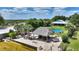 Waterfront home with a tiki hut and an above ground pool in a lush tropical setting at 1395 S Lake Reedy Blvd, Frostproof, FL 33843
