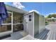 Exterior view of outdoor storage shed with adjacent enclosed porch area at 1395 S Lake Reedy Blvd, Frostproof, FL 33843