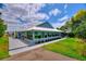 Beautiful view of the exterior with a long covered porch lined with windows and a neatly manicured lawn at 1395 S Lake Reedy Blvd, Frostproof, FL 33843