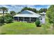 Back yard of home with sprawling green grass and covered outdoor space great for entertaining or relaxing at 1395 S Lake Reedy Blvd, Frostproof, FL 33843