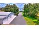 View of large garages and home with mature landscaping that offers privacy and enhances the curb appeal at 1395 S Lake Reedy Blvd, Frostproof, FL 33843