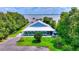 A charming, well-maintained home is surrounded by lush landscaping and offers a serene view of the lake at 1395 S Lake Reedy Blvd, Frostproof, FL 33843