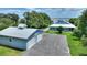 Exterior view of home featuring a metal roof, a two car garage, and scenic landscaping at 1395 S Lake Reedy Blvd, Frostproof, FL 33843