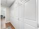 Hallway with white cabinets and wood floors for plenty of storage and bright, clean living at 1395 S Lake Reedy Blvd, Frostproof, FL 33843