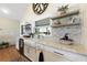 Bright kitchen features an island with countertop, farm sink, and tiled backsplash at 1395 S Lake Reedy Blvd, Frostproof, FL 33843