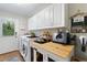Bright laundry room with built-in cabinets and a view to the backyard at 1395 S Lake Reedy Blvd, Frostproof, FL 33843