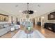 Bright and airy living room featuring wood floors, a modern ceiling fan, and open layout to the kitchen at 1395 S Lake Reedy Blvd, Frostproof, FL 33843