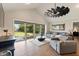 Bright living room with vaulted ceilings, sliding glass doors, and comfortable seating, creating an inviting space at 1395 S Lake Reedy Blvd, Frostproof, FL 33843