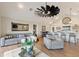Well-lit living room offers comfortable seating, stylish decor, and seamless flow to the adjacent kitchen and dining area at 1395 S Lake Reedy Blvd, Frostproof, FL 33843