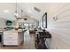 An open living area with a bar, and a screened porch with a view of the backyard at 1395 S Lake Reedy Blvd, Frostproof, FL 33843