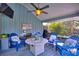 Comfortable screened-in patio with blue Adirondack chairs and a ceiling fan at 1395 S Lake Reedy Blvd, Frostproof, FL 33843