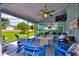 Inviting screened-in patio with comfortable seating and a ceiling fan overlooking the backyard at 1395 S Lake Reedy Blvd, Frostproof, FL 33843