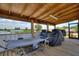 Covered patio featuring wood ceiling, views of the water, hammock, and grill at 1395 S Lake Reedy Blvd, Frostproof, FL 33843