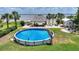 Inviting above-ground pool and patio area, perfect for entertaining and enjoying waterfront scenery at 1395 S Lake Reedy Blvd, Frostproof, FL 33843