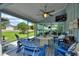 Screened-in porch boasts an outdoor dining area, a ceiling fan, and a view of the yard at 1395 S Lake Reedy Blvd, Frostproof, FL 33843
