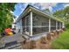 A screened-in porch is shown with comfortable outdoor seating and a fan at 1395 S Lake Reedy Blvd, Frostproof, FL 33843