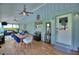 Enclosed porch offers dining area, lounge seating and access to the outdoors at 1395 S Lake Reedy Blvd, Frostproof, FL 33843