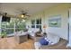 Comfortable screened porch features cozy seating, ceiling fan, and tranquil decor at 1395 S Lake Reedy Blvd, Frostproof, FL 33843