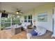 Comfortable screened-in porch with stylish seating, ceiling fan, and outdoor decor, creating a cozy retreat at 1395 S Lake Reedy Blvd, Frostproof, FL 33843