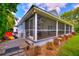 The screened porch features comfortable seating with ample space for relaxation and entertaining in a covered setting at 1395 S Lake Reedy Blvd, Frostproof, FL 33843