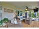 Relaxing screened-in porch featuring comfortable wicker seating and a ceiling fan, great for outdoor living at 1395 S Lake Reedy Blvd, Frostproof, FL 33843