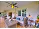 The spacious screened porch with comfortable furniture and a ceiling fan provides a relaxing outdoor living area at 1395 S Lake Reedy Blvd, Frostproof, FL 33843