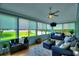 Relaxing sunroom with comfortable seating, a ceiling fan, and backyard views at 1395 S Lake Reedy Blvd, Frostproof, FL 33843