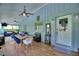 Inviting sunroom with wood floors, dining area, and sitting area with natural light at 1395 S Lake Reedy Blvd, Frostproof, FL 33843