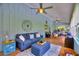 Spacious sunroom with wood floors, comfortable seating, ceiling fans, and bright natural light at 1395 S Lake Reedy Blvd, Frostproof, FL 33843